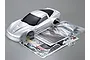 Killerbody 1/10 scale silver Corvette GT2 RC car body shell with included decal sheet, instruction manual, and plastic accessory parts in bags.