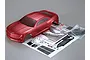 A red metallic 1/10 scale 2011 Camaro RC body shell with included decal sheets and plastic accessory parts on a grey background.