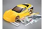 Killerbody 1/7 scale yellow Corvette GT2 RC car body shell with included decal sheets, instruction manual, and plastic parts in clear bags.