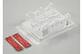 A clear polycarbonate RC truck seat insert with two strips of 3M VHB double-sided adhesive tape on a light grey background.