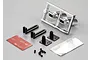 Killerbody 1/10 scale RC exhaust pipe set including chrome exhaust tips on a sprue, mounting brackets, screws, adhesive tape, and heat shield material.