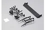 Black plastic RC car parts including a spoiler, light buckets, and trim pieces on a grey background.