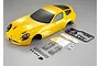 A yellow 1/10 scale Alfa Romeo TZ3 Corsa RC body shell with included plastic accessory parts, decals, and mounting hardware on a grey background.