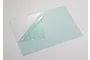A rectangular sheet of clear Lexan polycarbonate with a protective film partially peeled back, resting on a white surface.