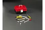 A miniature red and black plastic toolbox with a set of small toy tools arranged in front on a dark grey surface.