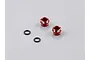Two red aluminium LED light holders and two black rubber O-rings on a grey background.