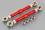 Two red anodized aluminium steering linkages with silver ball joints and four small metal spacers on a grey reflective surface.