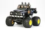 A Tamiya Midnight Pumpkin 1/12 scale RC monster truck in black with blue flame decals, yellow wheels, and oversized off-road tires.