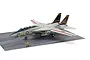 A fully assembled and painted 1/48 scale Tamiya Grumman F-14A Tomcat model aircraft displayed on a simulated aircraft carrier deck base with a crew figure.