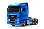 A studio shot of a Tamiya 1/14 scale MAN TGX 26.540 RC semi-truck model in light metallic blue against a white background.