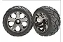 Two Traxxas 2.8-inch Anaconda RC car tyres pre-mounted on black chrome All-Star wheels against a white background.