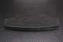 A black urethane foam bumper for an RC car, featuring the GPM Racing logo, set against a carbon fiber textured background.