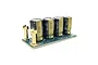Castle Creations capacitor pack featuring four electrolytic capacitors mounted on a green circuit board with two gold-coloured screw terminals.