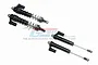 A set of four GPM Racing black aluminium L-shape piggyback shock absorbers for RC cars, shown with two assembled with springs and two without.