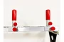 A T-Bone RC car wall rack featuring an aluminum frame with adjustable red-capped vertical supports and red adjustment knobs.
