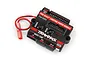 Traxxas Pro Scale Lighting Power Module for TRX-4 RC vehicles, featuring a black housing with red accents, multiple ports, and a red connector wire.