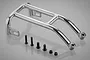 A chrome-plated steel RC roll cage part with four black screws and two black nuts arranged on a reflective grey surface.