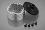 A silver aluminium differential housing with a black end cap and four small black screws on a grey reflective surface.