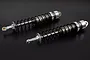 Two Rovan silver aluminium heavy-duty rear shock absorbers for RC cars, featuring black coil springs and threaded bodies.