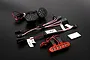Rovan RC light controller kit featuring two round LED headlight units, a red LED light bar, control module, and wiring harnesses on a black background.