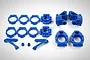 A set of blue plastic RC car suspension components including hubs, carriers, and mounting brackets arranged on a white background.