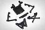 A set of black plastic RC car spare parts including a bulkhead, shock tower, and suspension components on a white background.