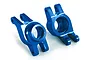 Two blue anodized aluminum rear stub axle carriers for a Traxxas RC car, shown from an angled perspective against a white background.