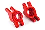 Two red anodized aluminum rear stub axle carriers for a Traxxas RC vehicle, shown from a side angle on a white background.