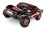 Traxxas Slash 1/10 scale RC short course truck with black and red body, off-road tires, and functional front LED lights.