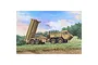 An artistic illustration of a tan THAAD missile launcher vehicle parked in a grassy field against a blue sky.