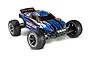Traxxas Rustler XL-5 RC stadium truck in blue and black livery with front LED lights, viewed from a front three-quarter angle on a white background.