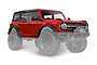 A red Traxxas TRX-4 2021 Ford Bronco painted body shell with black roof and trim, shown mounted on a chassis with large off-road tires.