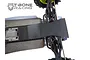 A T-Bone Racing black nylon chassis skid plate installed on the rear of an RC monster truck chassis against a white background.