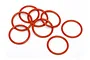 A cluster of eight orange rubber O-rings arranged on a plain white background.
