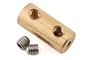 A brass cylindrical motor coupler for an RC boat with two threaded holes and two accompanying steel grub screws.