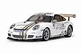 A studio shot of a Tamiya 1/10 scale RC Porsche 911 GT3 Cup VIP car model, featuring a white body with gold and black racing stripes and sponsor decals.