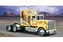 An illustration of a yellow American Superliner model truck named Lady Butterfly with butterfly and woman graphics on the side, set against a desert landscape.