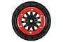 A Pro-Line F-11 short course beadlock rim featuring a black wheel hub and a contrasting red beadlock ring with silver screws.