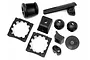 A set of various black plastic RC car parts including nut holders, spacers, and ball joints on a white background.