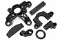 A set of black plastic RC car parts including a large gear mount, engine mount, and various brackets for HPI Baja models.