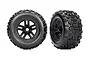 Two Traxxas Sledgehammer 3.8-inch monster truck tires pre-mounted on black five-spoke wheels, shown from front and angled views.