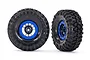 Two Traxxas 1.9 inch Canyon Trail RC crawler tires mounted on black and blue beadlock-style wheels against a white background.