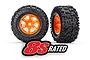 Two Traxxas X-Maxx RC monster truck wheels with black all-terrain tires and bright orange rims, featuring an 8S RATED logo overlay.