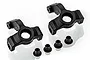 Two black plastic RC steering hubs and four small black bushings arranged on a white background.