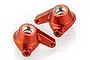 Two orange anodized aluminium steering hub carriers for RC cars, shown from an elevated angle against a white background.