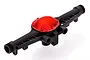 A black plastic RC car axle housing with a metallic red circular differential cover, viewed from an elevated angle against a white background.