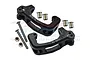 A pair of black GPM Racing aluminium C-hub steering carriers with included screws, nuts, and metal bushings on a white background.