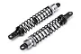 Two assembled silver aluminium RC off-road shock absorbers with black springs on a white background.