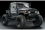 A studio shot of a grey MST CFX-W J45C RC crawler truck on a black background.