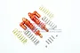 Two orange GPM aluminium piggyback shock absorbers for Traxxas Rustler 4x4 with extra gold and silver springs and mounting hardware.